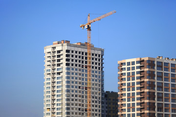 Fototapeta na wymiar Kiev, Ukraine - February 17, 2019: The construction of a new monolithic multi-storey buildings. Unfinished building сonstruction. Construction site with crane. Modern apartment buildings