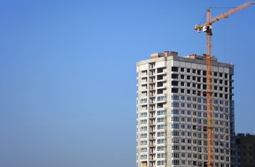 Fototapeta na wymiar Kiev, Ukraine - February 17, 2019: The construction of a new monolithic multi-storey building. Unfinished building сonstruction. Construction site with crane. Modern apartment building