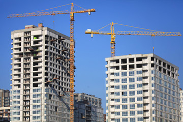 Fototapeta na wymiar Kiev, Ukraine - February 17, 2019: The construction of a new monolithic multi-storey buildings. Unfinished building сonstruction. Construction site with cranes. Modern apartment buildings