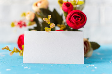 business card with a bouquet of flowers on a blue background