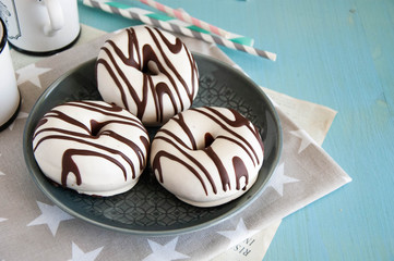 Donuts with white chocolate on a wooden blue background