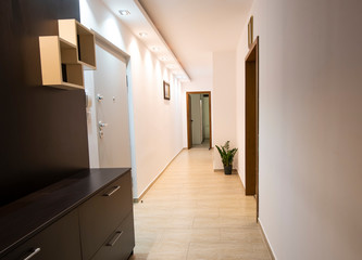 A long corridor with lights in an apartment. Entrance to the apartment