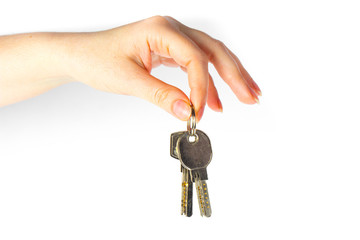 House keys in the female hand on a white background