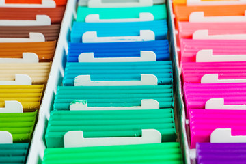 Rainbow colors of modeling clay. Multicolored plasticine bars ina box, background texture