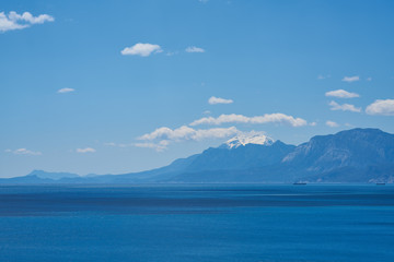 Mountain, sea, sky and white clouds