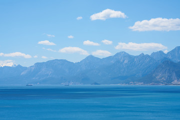 Mountain, sea, sky and white clouds