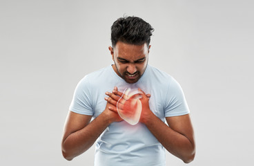 people, healthcare and health problem concept - unhappy man having heart attack or heartache over grey background