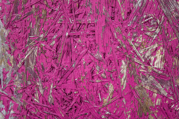 pink fiberboard with shabby paint. rough surface texture