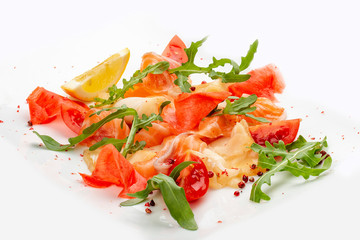 Sliced fish, salmon and perch with arugula and tomatoes. On white background