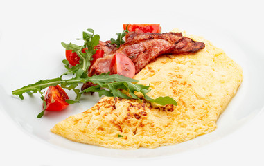 Omelet with bacon and tomatoes on white background