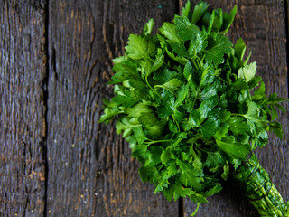 Fresh parsley leaves on wooden background. Top view
