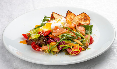 Poached egg with croutons and vegetable salad on white background
