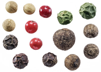 Black, white, green and red peppercorns isolated on white background.