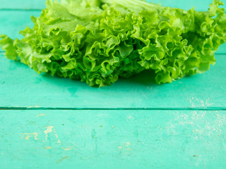Fresh lettuce leaves on wooden background. Top view