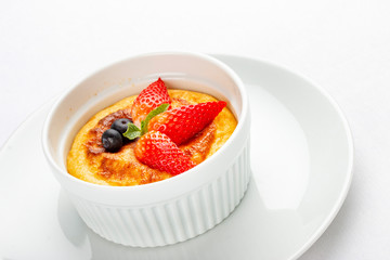 Baked cottage cheese dessert with strawberry on white background