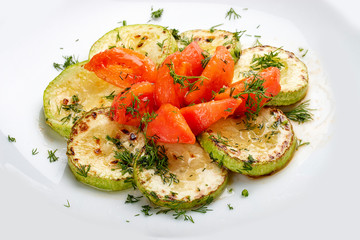 Grilled zucchini with tomatoes on white background