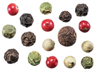 Black, white, green and red peppercorns isolated on white background.