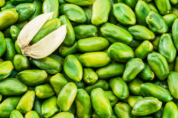 Lot of green pistachio nuts. Food background.
