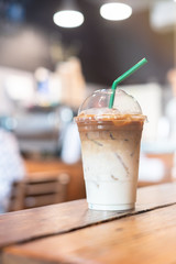 Iced latte coffee on wooden table in restaurant and cafe , background
