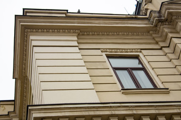 Wall of facade of old building with a corner and window..