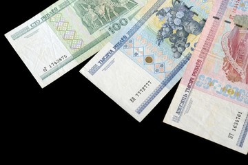 Outdated Belarusian rubles isolated on black close up