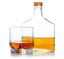 Glass with cognac and bottle cognac on a white background. Isolation