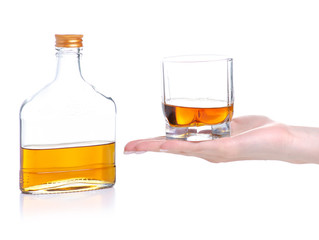 Glass with cognac and bottle cognac on a white background. Isolation