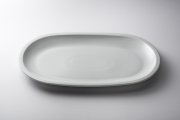 Isolated empty white oval plate
