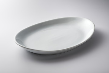 Isolated empty white oval plate