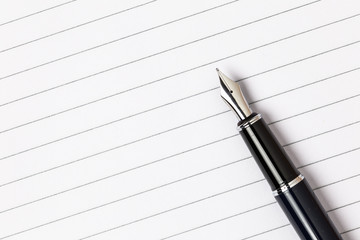 Top view. Blank notepad with pen