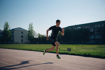 sprinter runs fast on a treadmill at the stadium