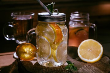 Homemade orange lime lenon lemonade on the dark rustic background