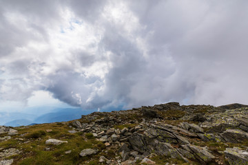 Fototapeta na wymiar Beautiful cloudy landscape in the Alps, in summer