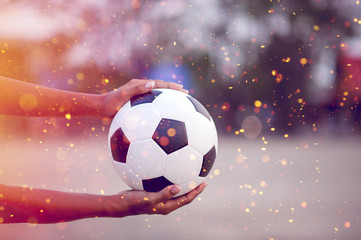 Fototapeta premium The cropped image of sports players who catch the ball and the football field. Sports-image concept.