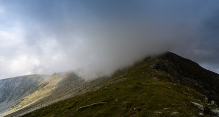 Mist and storm clouds in the mountains, in summer