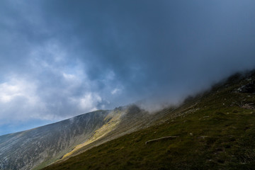 Mist and storm clouds in the mountains, in summer