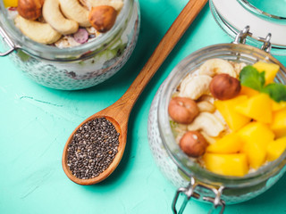 Chia seed pudding in jar with coconut milk, mango and nuts