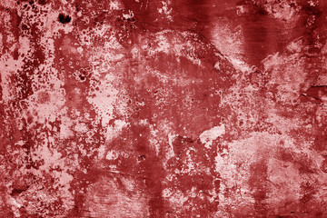 Grungy cement wall texture in red tone.