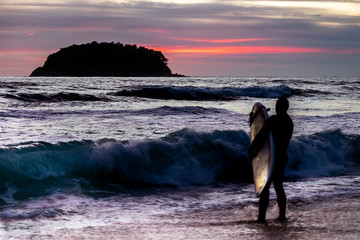 man surfing silhouette sunset phucket thailand