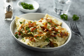 Traditional German dumplings with fried onion and herbs