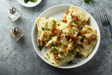 Traditional German dumplings with fried onion and herbs