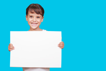 Girl showing blank white sign isolated on white background.