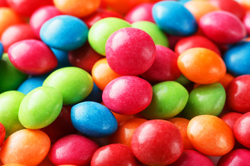 Rainbow colors of multicolored candies close-up, texture and repetition of dragee