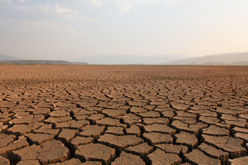 Fototapeta premium Dry river and lake after drought impact on summer, Landscape of Cracked earth metaphor climate change and drought