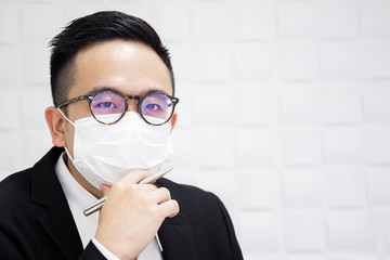 Portrait of businessman masked protective mask, businessman got sick because of unhealthy behaviour and over working.  Workaholic concept.