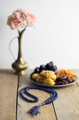 Sweets, dates, dried apricots on a plate. Flower. The concept of Ramadan, iftar.