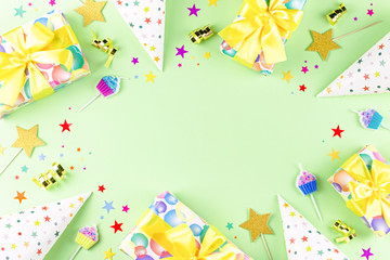 Fototapeta premium Birthday party background with wrapped gifts, confetti, party hats, decorations, top view