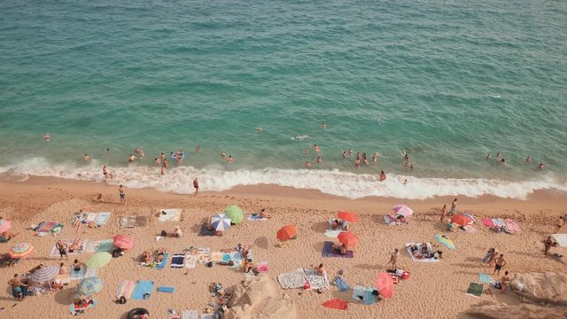 People at beach in Calella city. Spain.