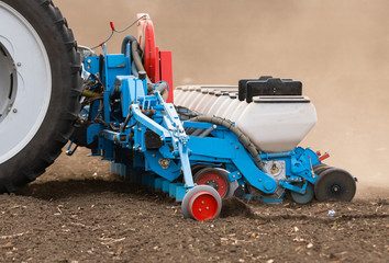  Farmer with tractor seeding soy crops at agricultural field