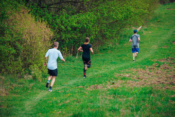 Trail runners in green spring nature